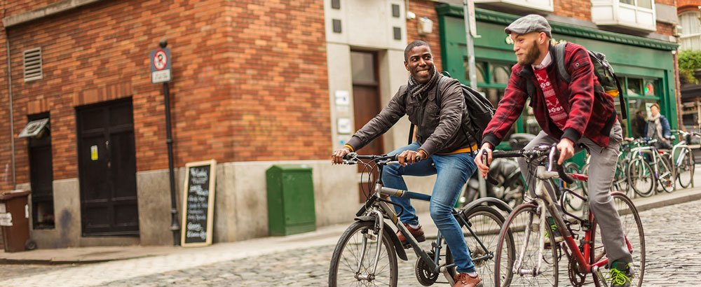 men cycling in the city